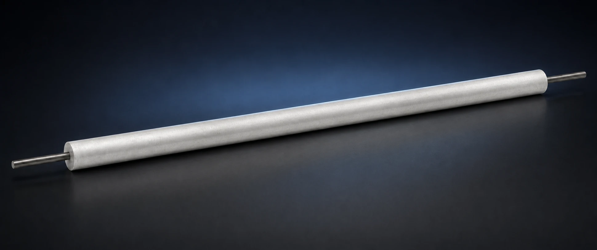 Long cylindrical magnesium sacrificial-anode body with a central steel core on a dark studio background