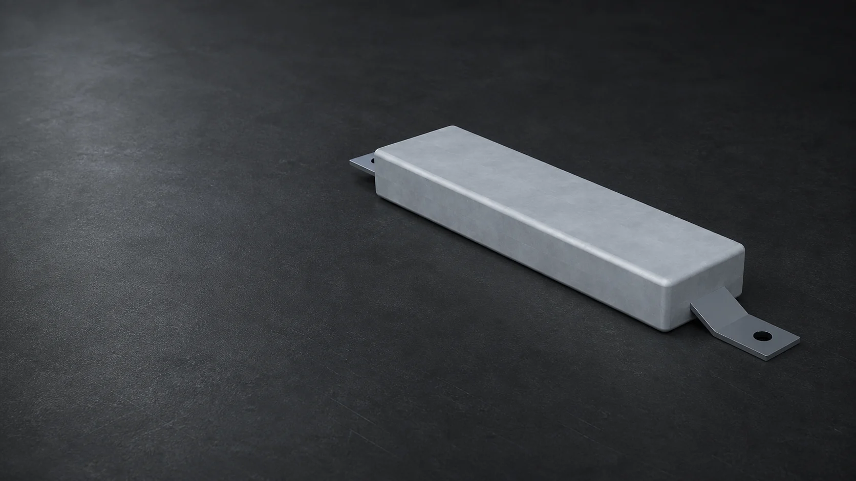 Rectangular cast sacrificial anode with a steel mounting insert on a dark studio background