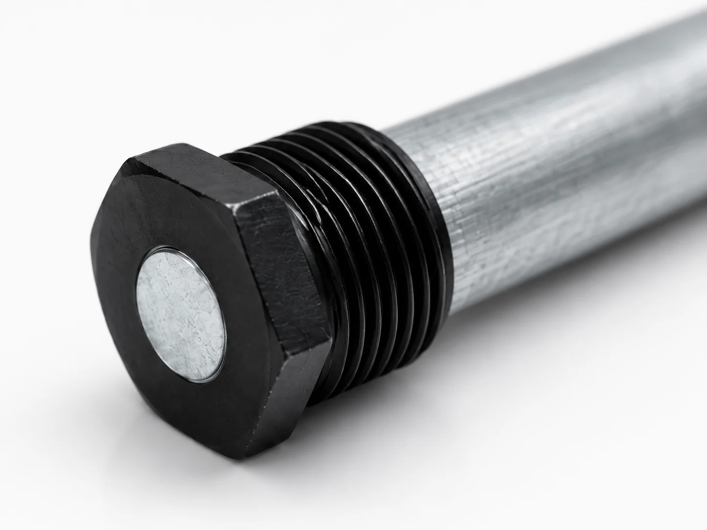 Close-up of magnesium anode rod hex plug and threaded connection